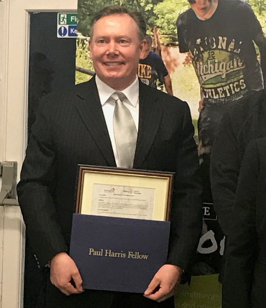 Receiving the Paul Harris Fellowship award from The Rotary Club.