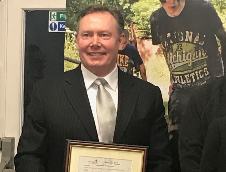 Receiving the Paul Harris Fellowship award from The Rotary Club.